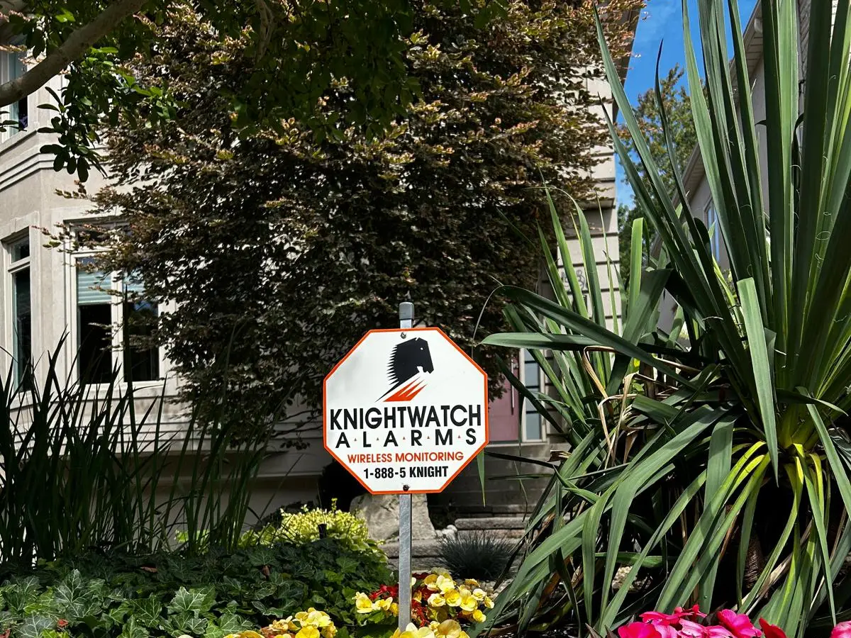 Knightwatch Alarms lawn sign in front of a home