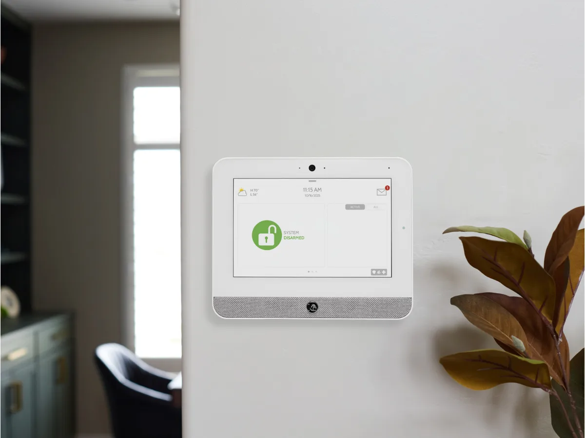 IQ Panel 5 security touchscreen mounted on a wall in a home