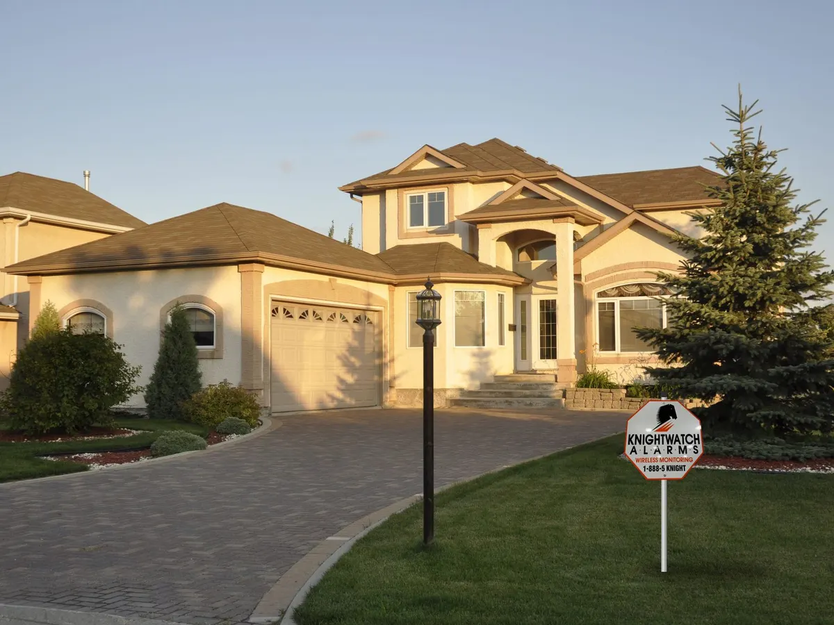 Executive home with a Knightwatch Alarms lawn sign